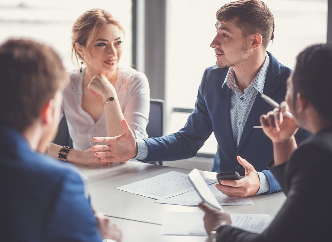 About Our Agency - Businesspeople Discussing Together in a Conference Room During Meeting at Office