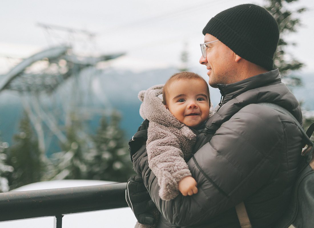 Rainier, OR - Father and Young Child Bundled up for the Winter and Looking Out in Toward the Distance Landscape