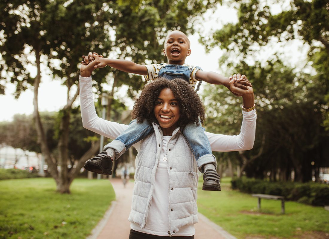 Read Our Reviews - Woman Giving Son a Piggyback Ride On Her Shoulders at the Park